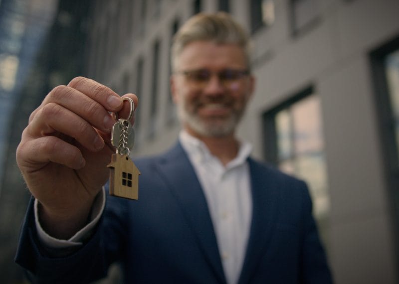 Business man senior mature businessman smiling real estate agent broker investor show bunch of keys new rental house office developer company city building owner rent realty mortgage lease apartment. High quality 4k footage