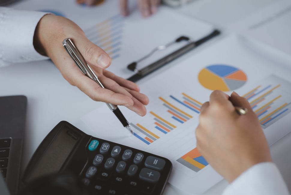 Two businessmen pointed to the material for the meeting, working together to plan to develop and solve common business problems. Concept of business management for growth and quality.